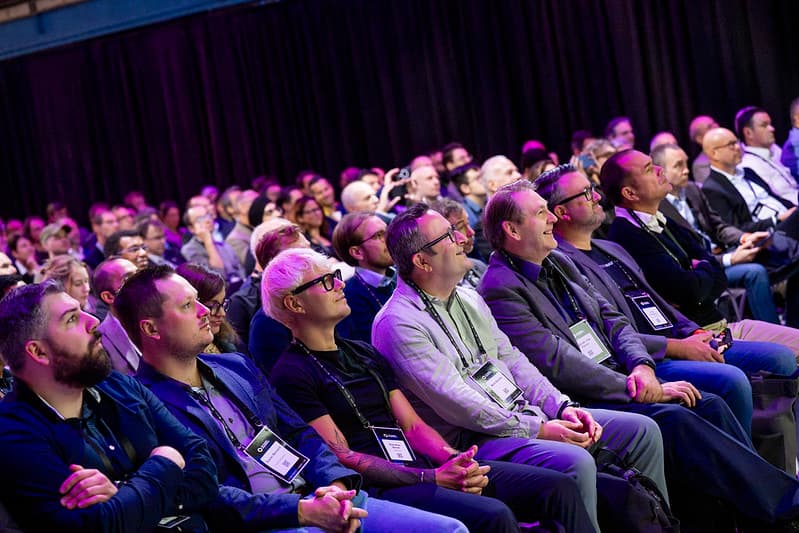 Attendees watching a session